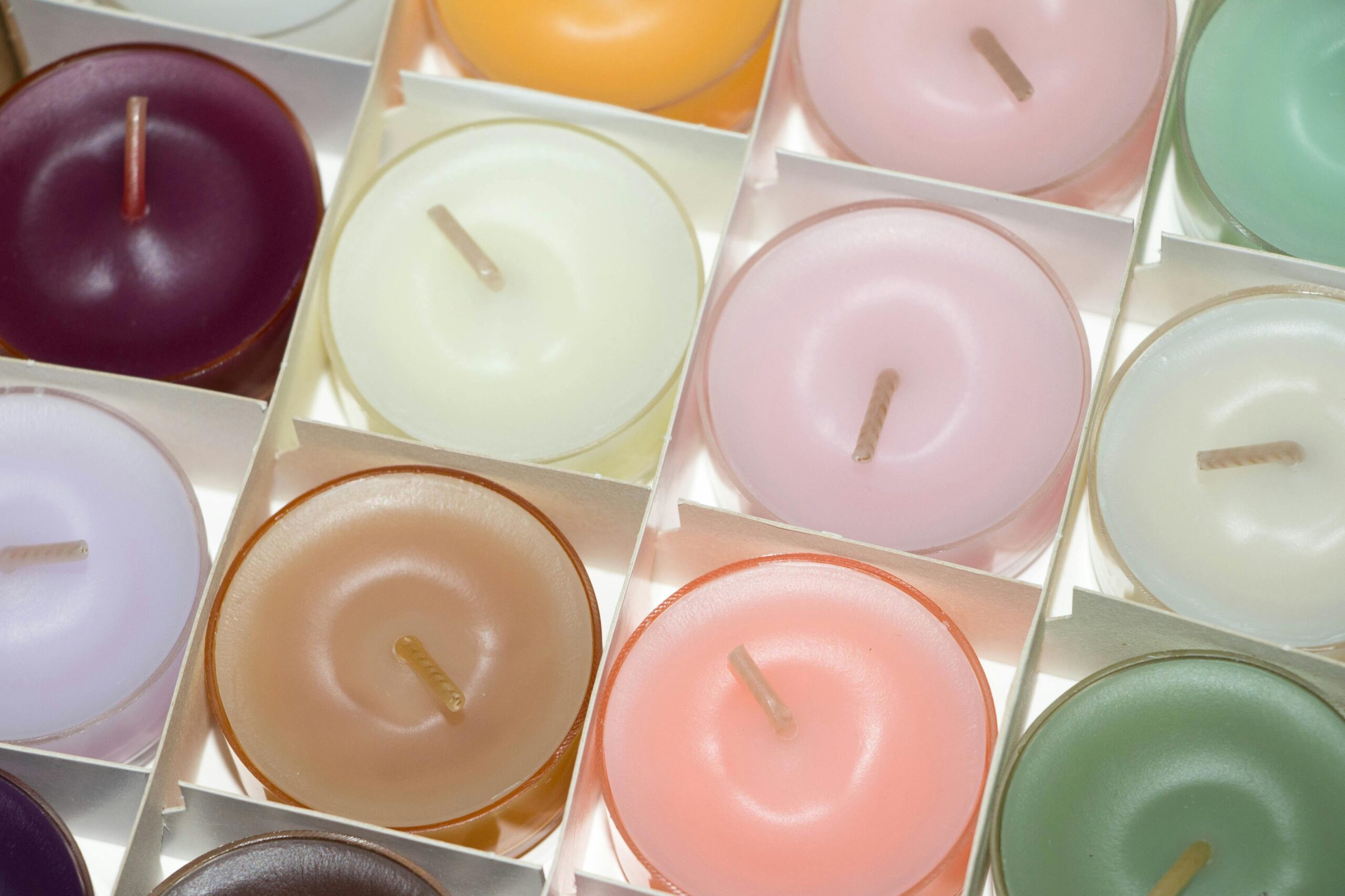 Arrangement of multi-colored/ pastel candles in packaging.