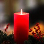 Photo of the christmas collection "cinnamon candle". Picture of red candle on a pine tree.