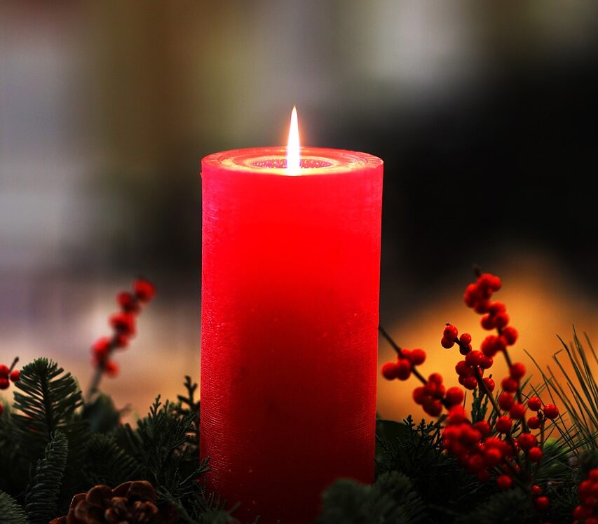 Photo of the christmas collection "cinnamon candle". Picture of red candle on a pine tree.